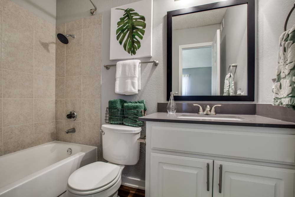 A bathroom with a full sized bathtub at Verandahs at Cliffside Apartments in Arlington, Texas
