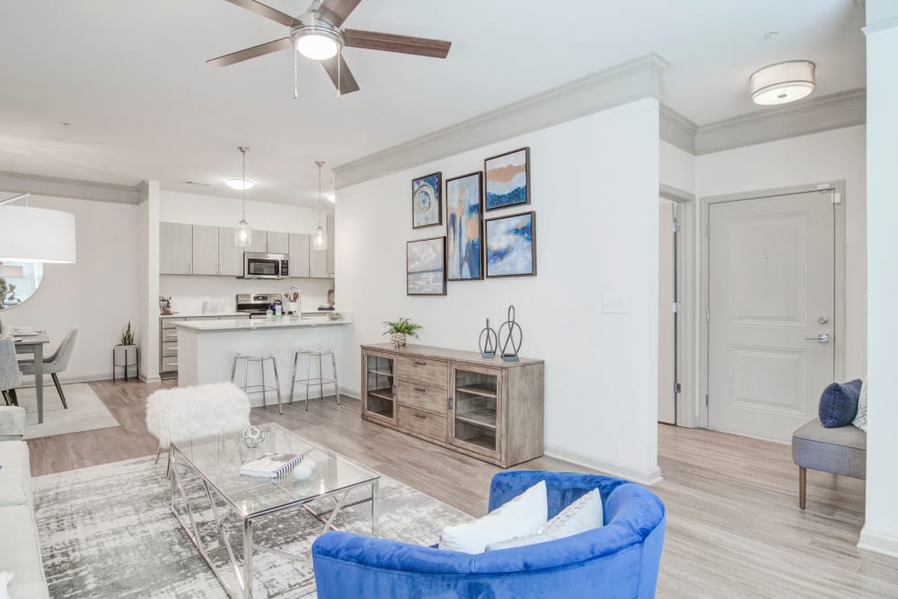 A model apartment living room and hallway to the bedrooms at Bradley Park Apartments in Cumming, Georgia