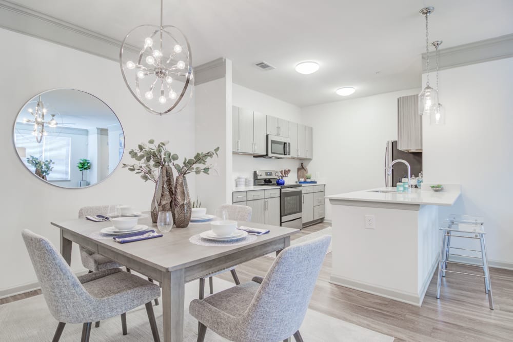 A decorated dining room table next to the kitchen in an apartment at Bradley Park Apartments in Cumming, Georgia