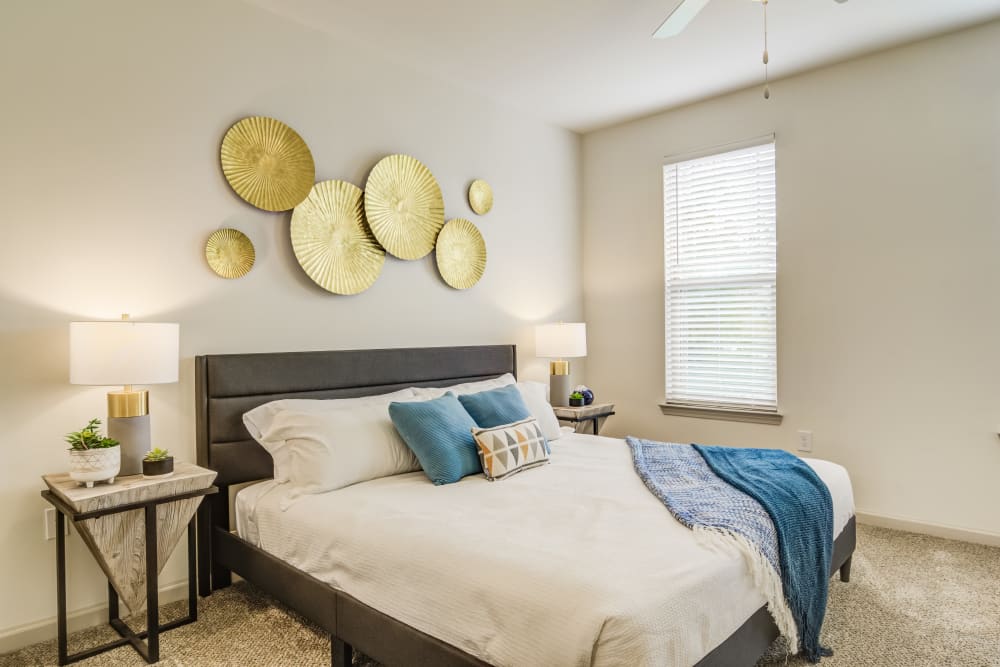 A furnished bedroom with a large closet in a model apartment at Brookside Heights Apartments in Cumming, Georgia