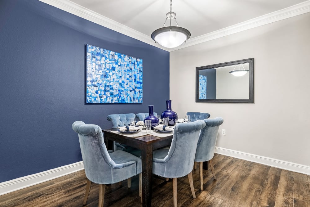 Dining room with a navy colored accent wall at Marquis on Pin Oak in Houston, Texas