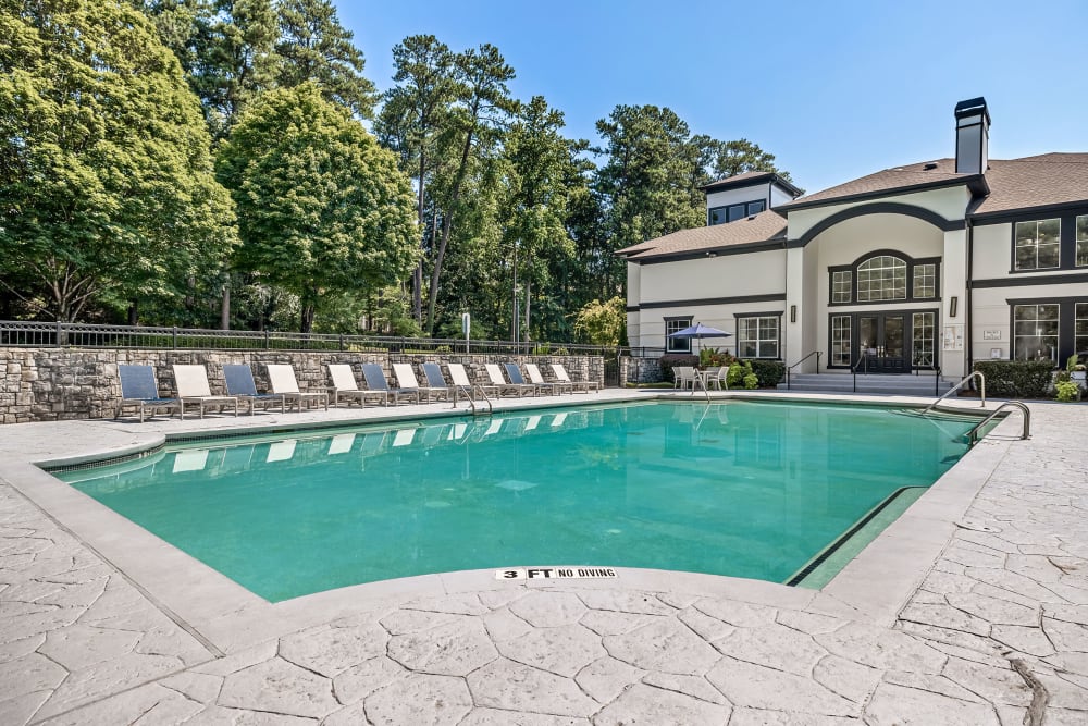 Swimming pool with lounge chairs on deck at Marq Perimeter in Atlanta, Georgia