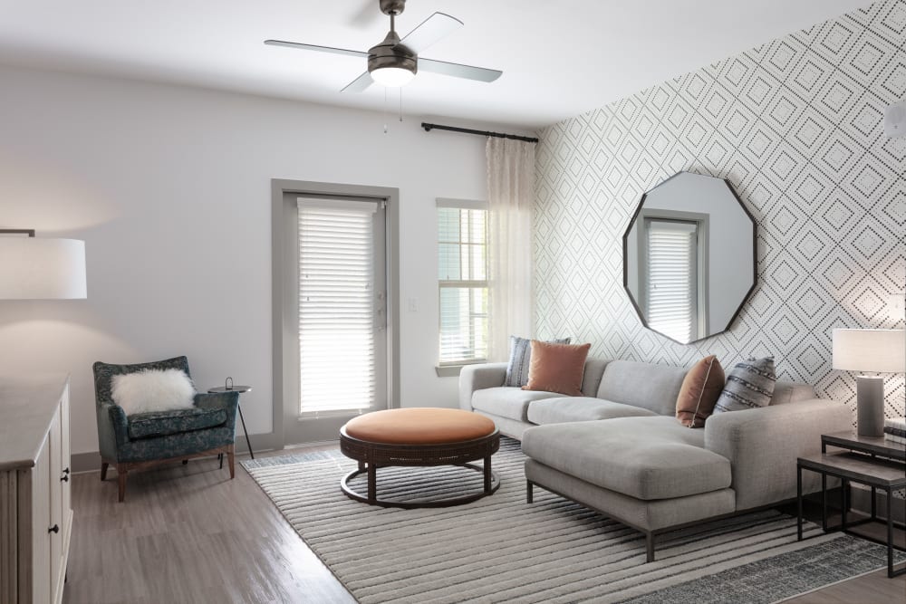 Spacious living room with ceiling fan at Alleia Luxury Apartments in Savannah, Georgia