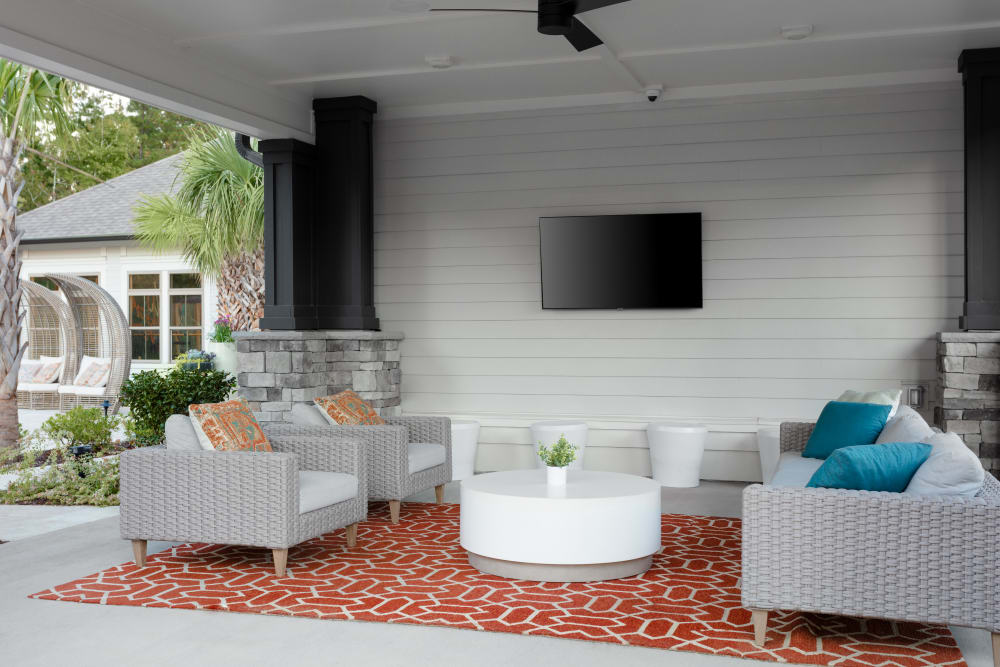 Covered outdoors lounge with TV at Alleia Luxury Apartments in Savannah, Georgia