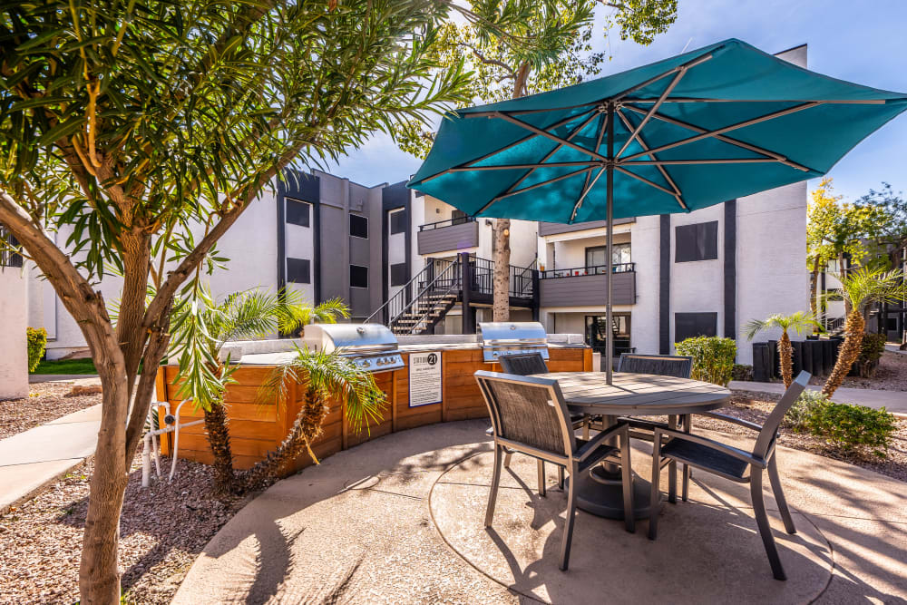 Outdoor grill station with picnic table at Station 21 Apartments in Mesa, Arizona