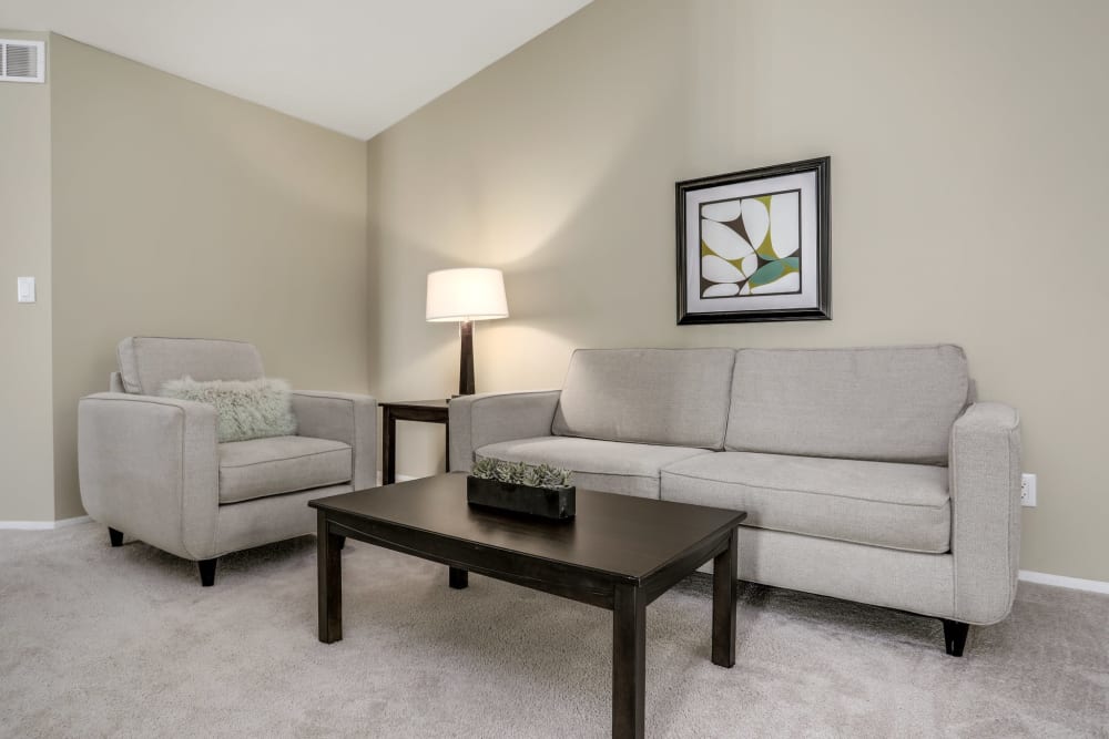 Living room of a furnished suite at Kensington Manor Apartments in Farmington, Michigan