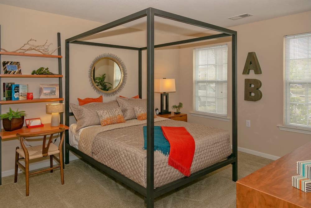 Spacious model bedroom with a modern canopy bed at Arbor Brook in Murfreesboro, Tennessee