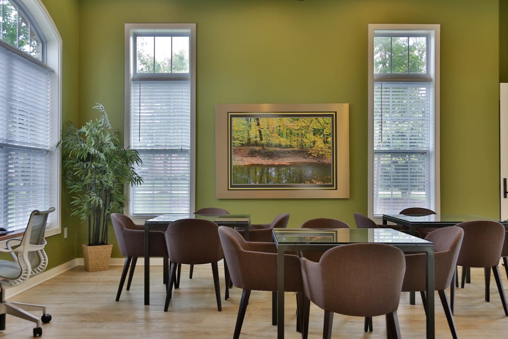 Resident lounge with several tables for remote work and plenty of natural light at Arbor Brook in Murfreesboro, Tennessee