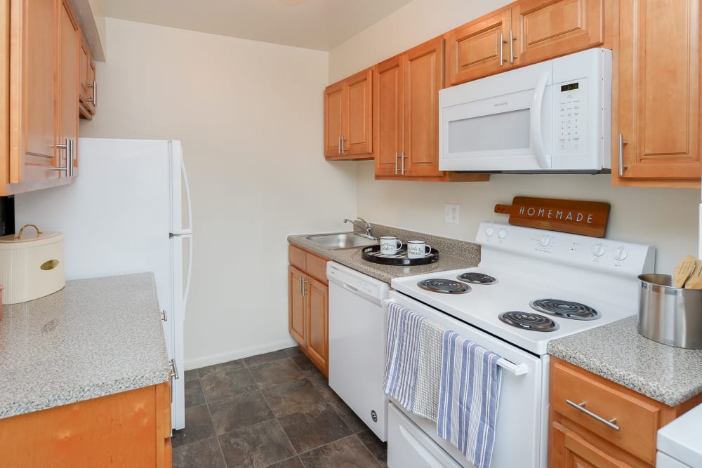 Kitchen with maple cabinets and white appliances