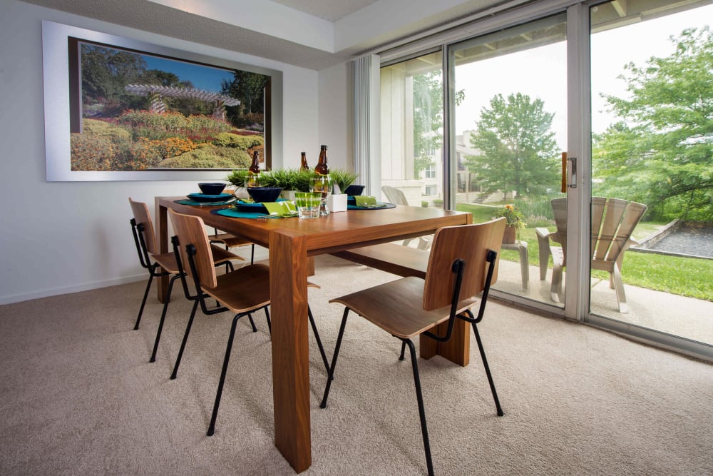Dining room and private patio of a model apartment at Briar Cove Terrace Apartments in Ann Arbor, Michigan