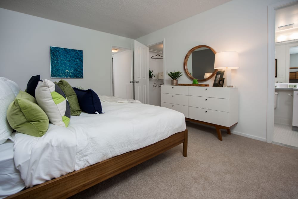 Model bedroom with walk-in closet and ensuite bathrom at Briar Cove Terrace Apartments in Ann Arbor, Michigan