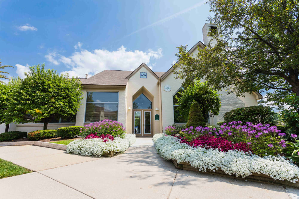 Leasing center with flowers in full bloom at Briar Cove Terrace Apartments in Ann Arbor, MI