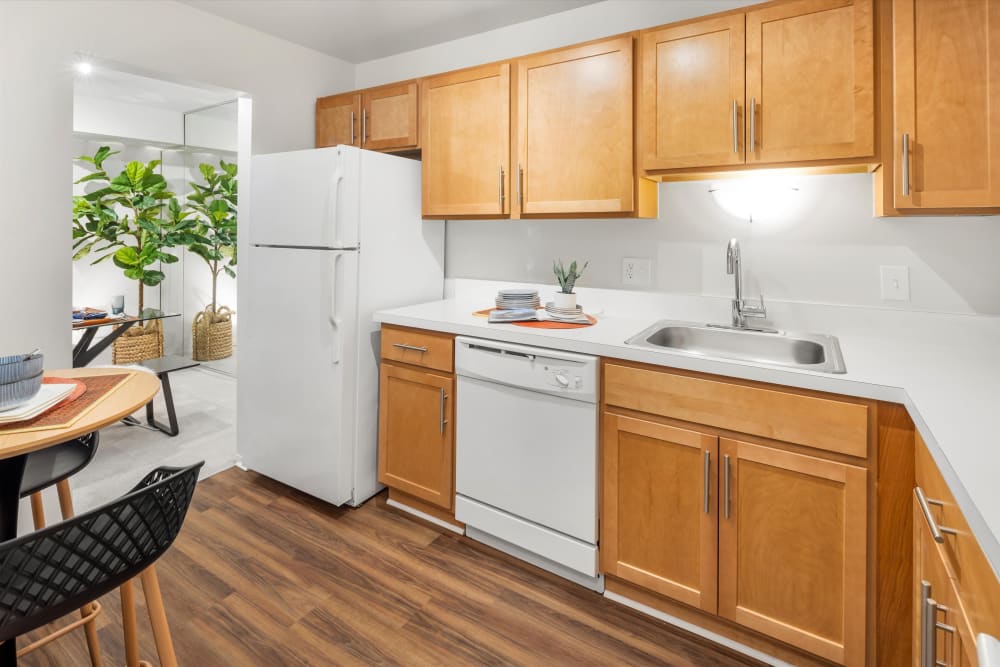 Eat-in kitchen with wood-style flooring at Fairmont Park Apartments in Farmington Hills, Michigan