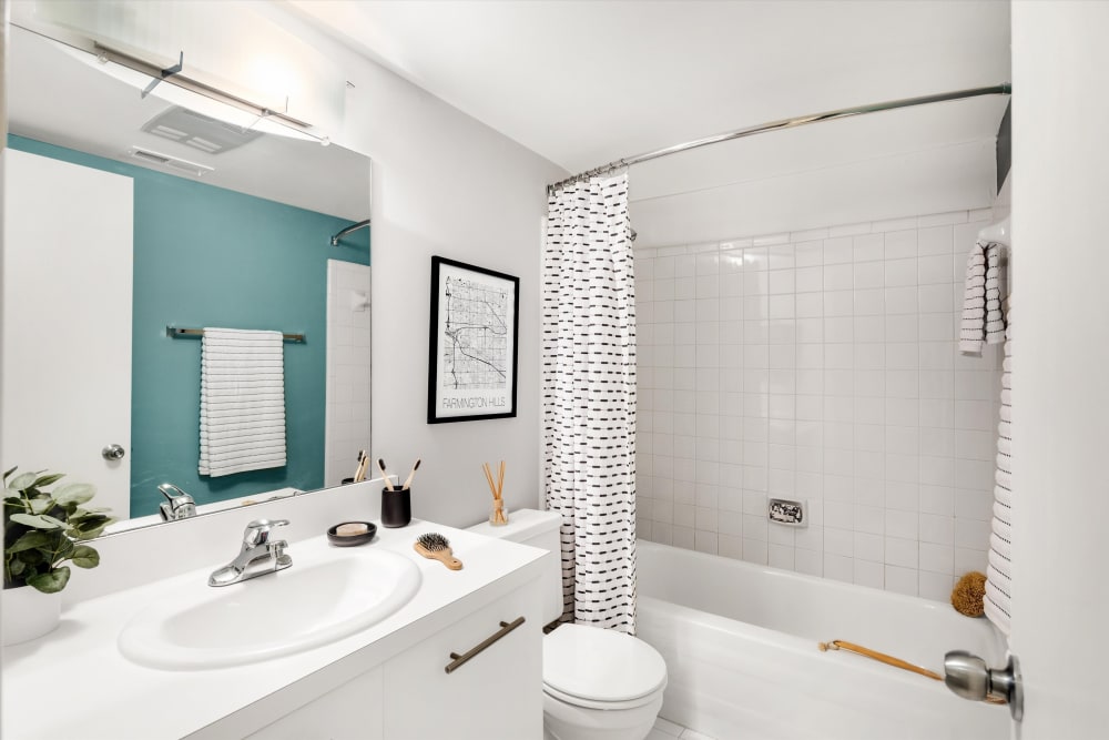 Bathroom with vanity and tiled tub/shower combination at Fairmont Park Apartments in Farmington Hills, Michigan