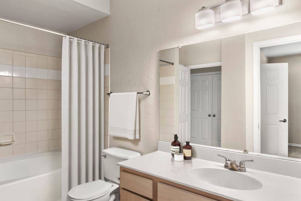 Model bathroom with a large shower at Harbortown Apartments in Orlando, Florida