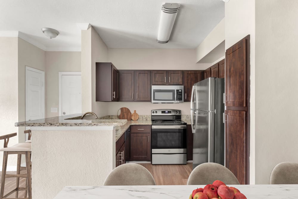 Model kitchen with a island at Harbortown Apartments in Orlando, Florida