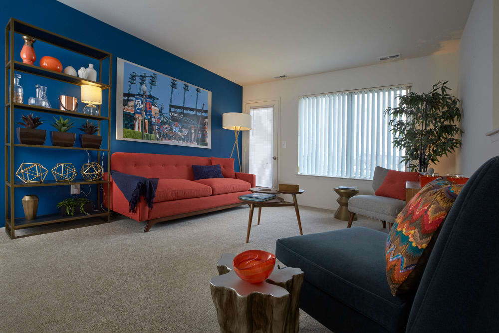 Model living room with blue accent wall at Lakeside Terraces in Sterling Heights, Michigan