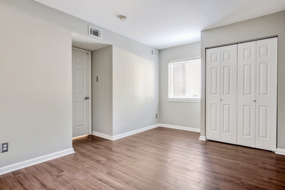 Bedroom with hardwood flooring and plenty of natural light in a model home at Heritage at Shaw Station in Washington, District of Columbia