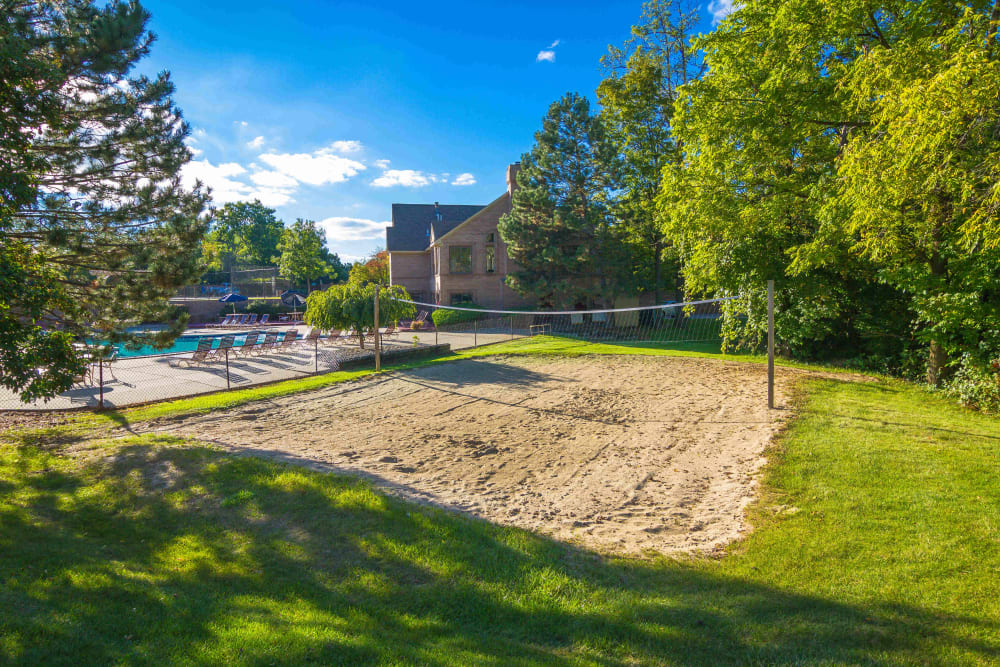 Sand volleyball court near the pool at Saddle Creek Apartments in Novi, Michigan