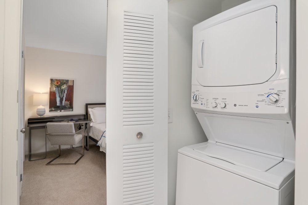 Stacked washer and dryer in a home at Saddle Creek Apartments in Novi, Michigan