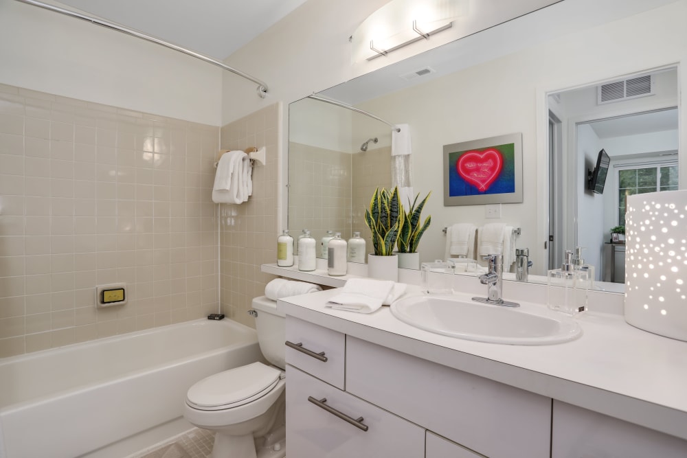 Bathroom with oversized vanity and tiled shower/tub combination at Saddle Creek Apartments in Novi, Michigan