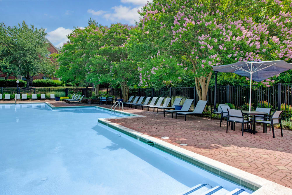 Pool side with table at Woodway at Trinity Centre in Centreville, Virginia