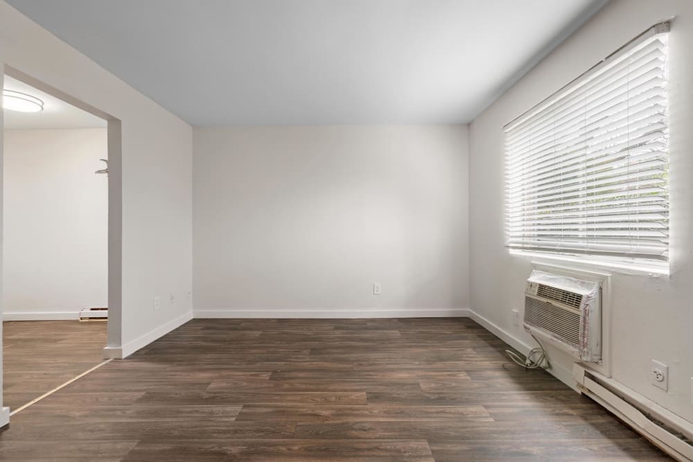Wood flooring and a large window in an apartment living room at Cobbs Creek Apartment Homes in Decatur, Georgia