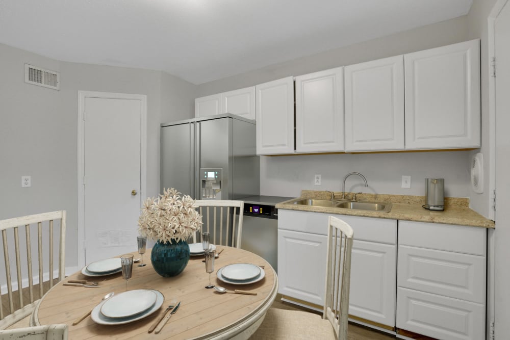 A model apartment dining room and kitchen at Garrett Woods Apartment Homes in Phenix City, Alabama