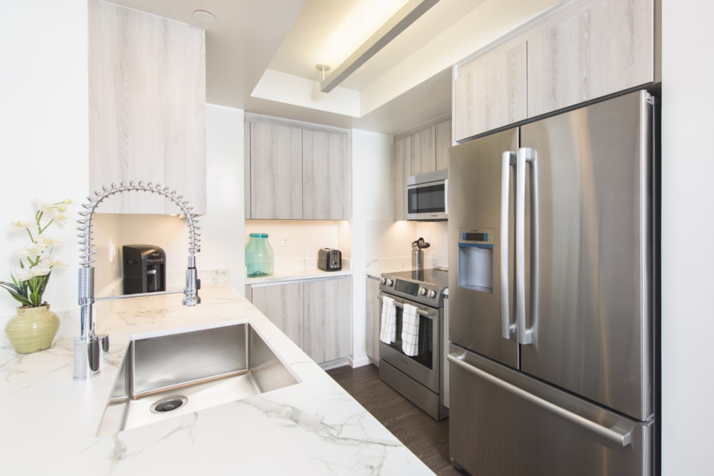 Kitchen with stainless steel appliances at 255 Grand in Los Angeles, California