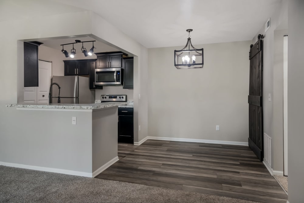 Dining space, and kitchen area at Waters Edge Apartments in Lansing, Michigan