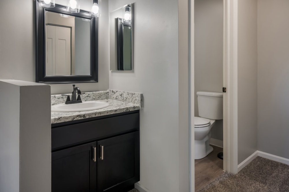 Bathroom with separate toilet space at Waters Edge Apartments in Lansing, Michigan
