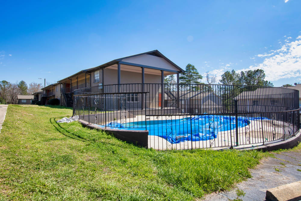 A covered, gated community swimming pool at Magnolia Manor Apartments in Center Point, Alabama
