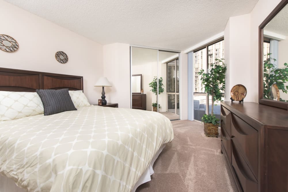Bedroom with a big window and bed at Promenade Towers in Los Angeles, California