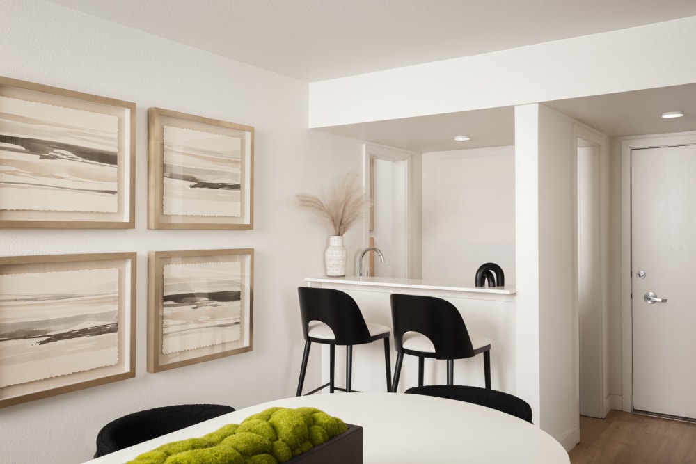 Bar stools at wet bar and artwork on wall at an apartment at Dolphin Marina Apartments in Marina Del Rey, California