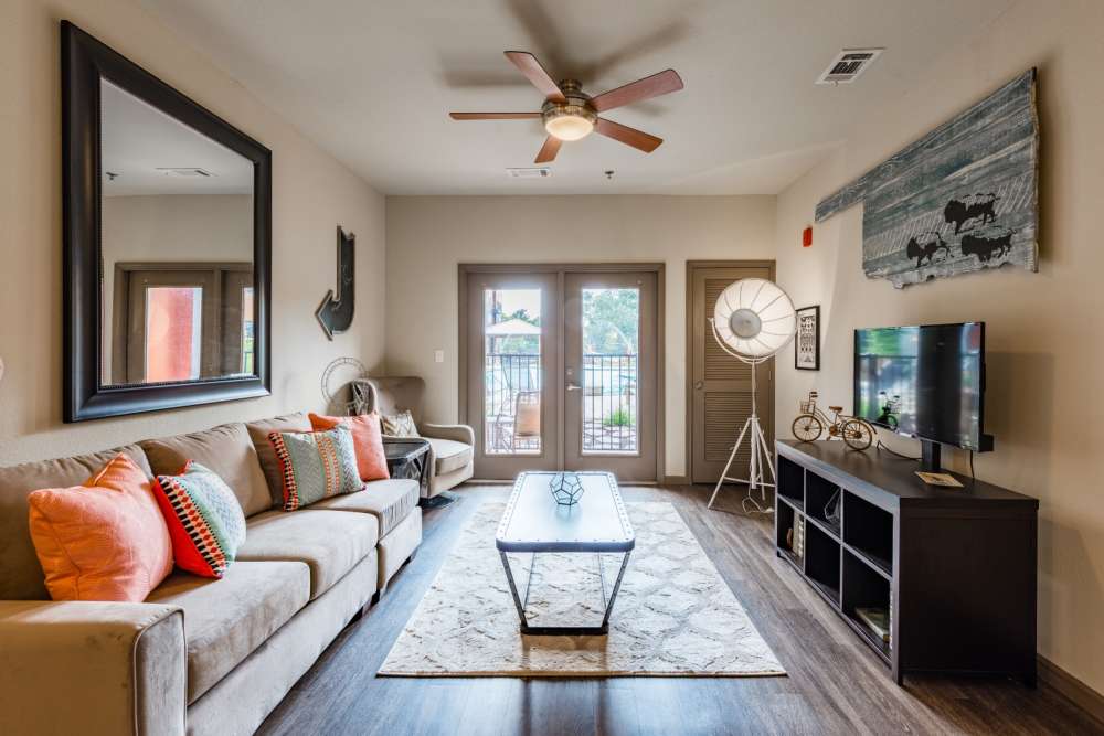 Living room with area rug and large sofa at The Quarters at Stillwater in Stillwater, Oklahoma