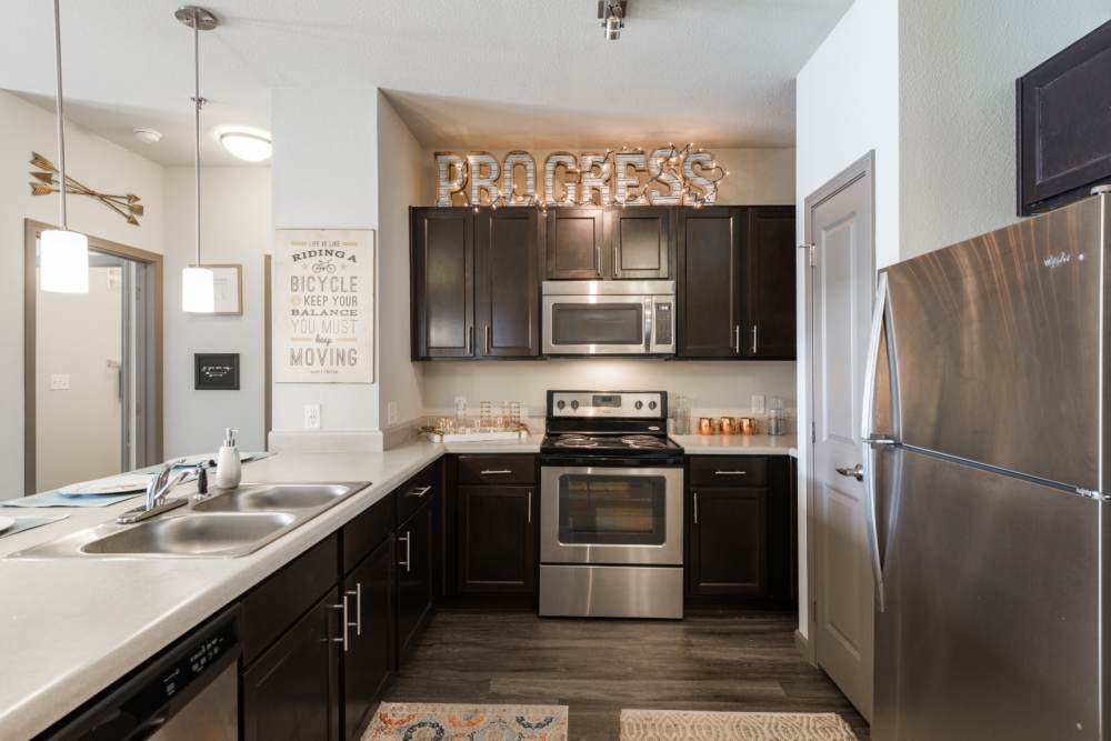 Apartment kitchen with stainless-steel appliances at The Quarters at Stillwater in Stillwater, Oklahoma