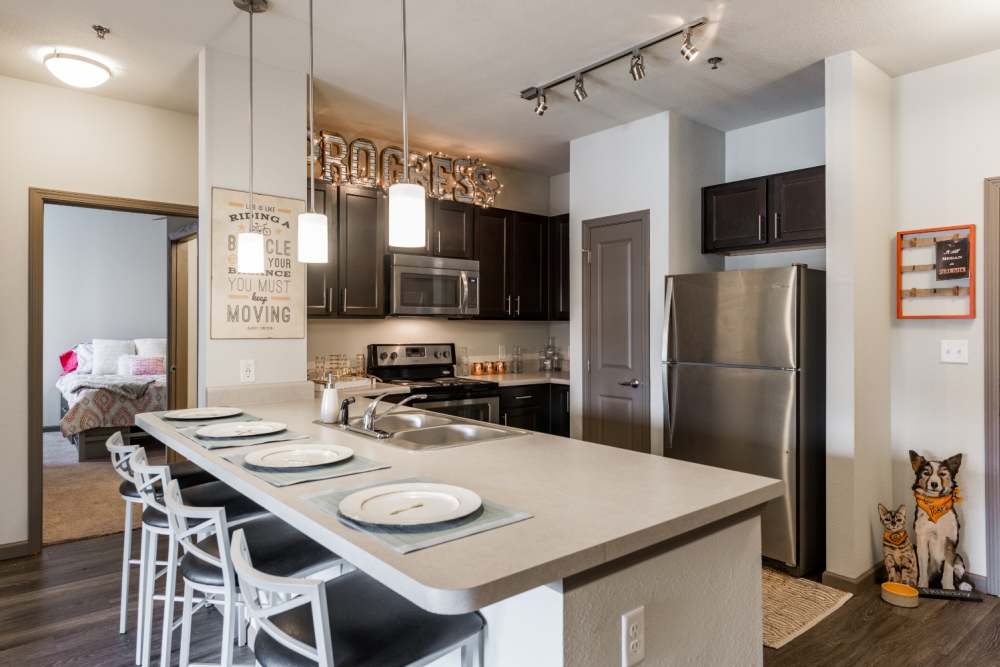 Eat-in kitchen with granite counters at The Quarters at Stillwater in Stillwater, Oklahoma