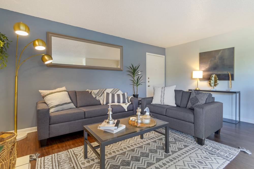 Living room with grey sofas at The Landing at College Station in College Station, Texas