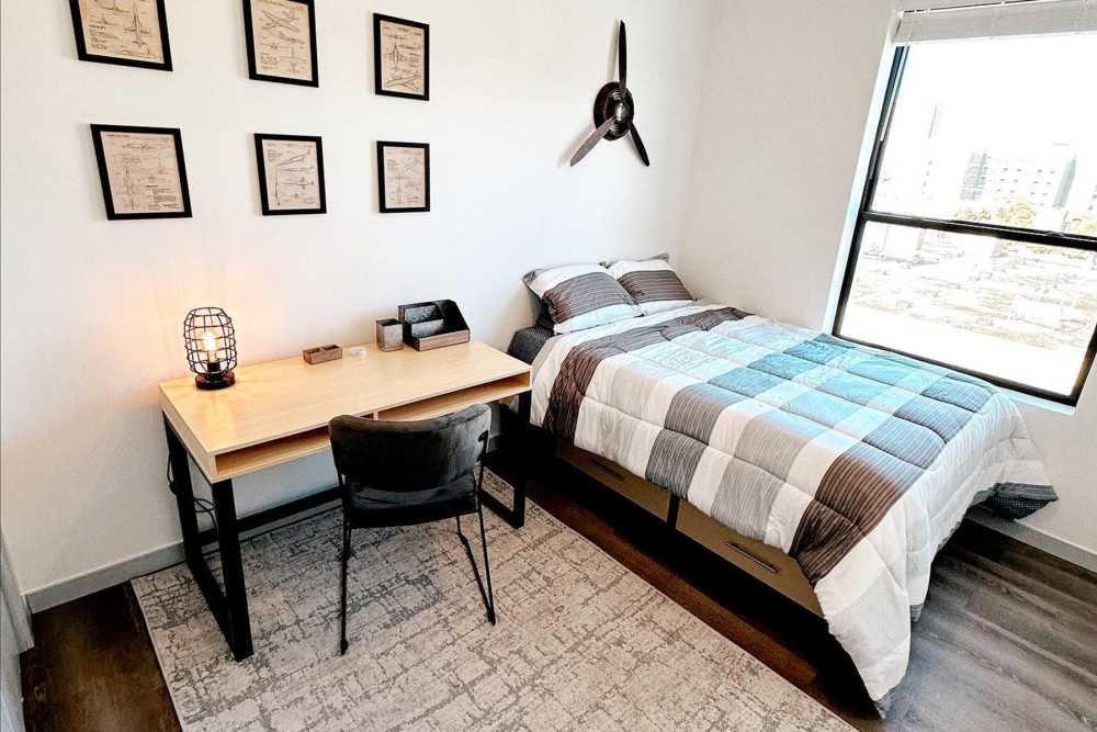 Bedroom with twin bed and desk at LivRed in Lincoln, Nebraska