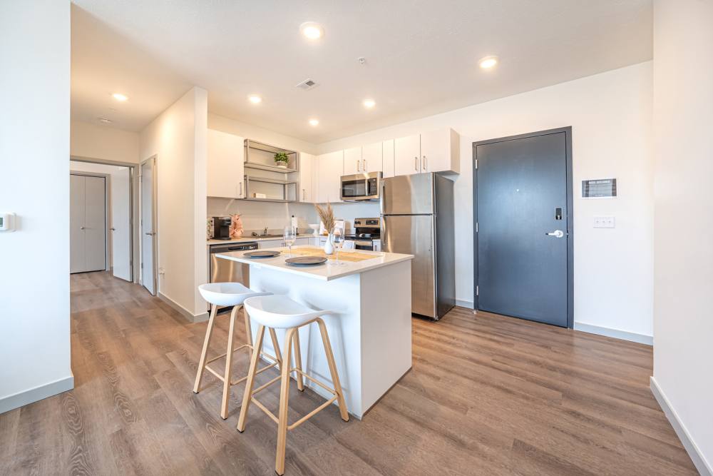 Apartment kitchen with stainless-steel appliances and hardwood floors at LivRed in Lincoln, Nebraska