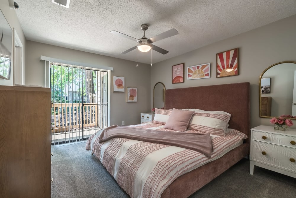 Model bedroom with a balcony at Edge at Lakeview in Memphis, Tennessee