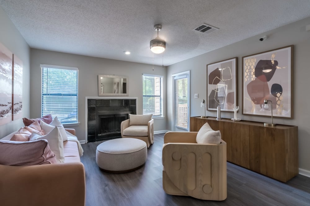 Model apartment with chairs, a couch, and art on the walls at Edge at Lakeview in Memphis, Tennessee