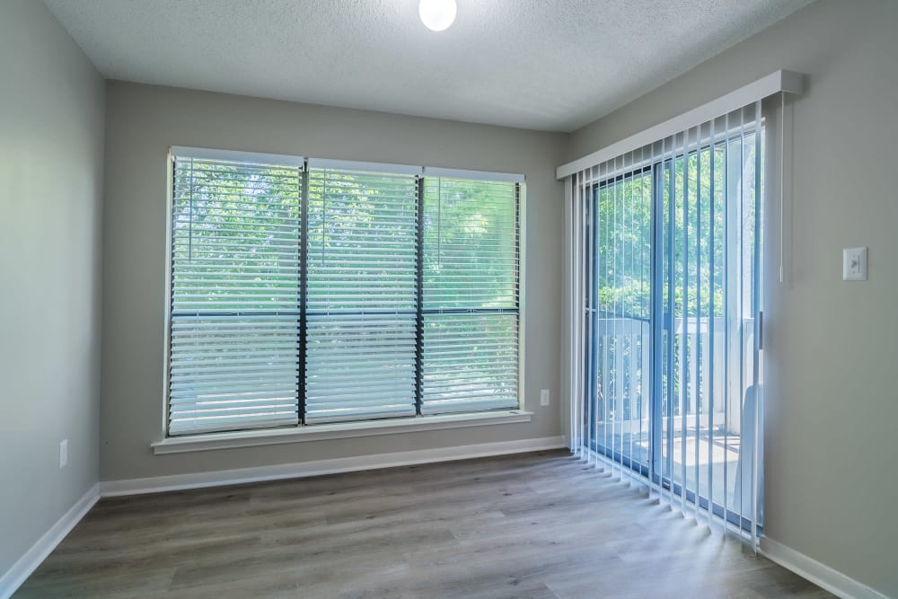 Empty secondary bedroom with a large window and balcony at Edge at Lakeview in Memphis, Tennessee