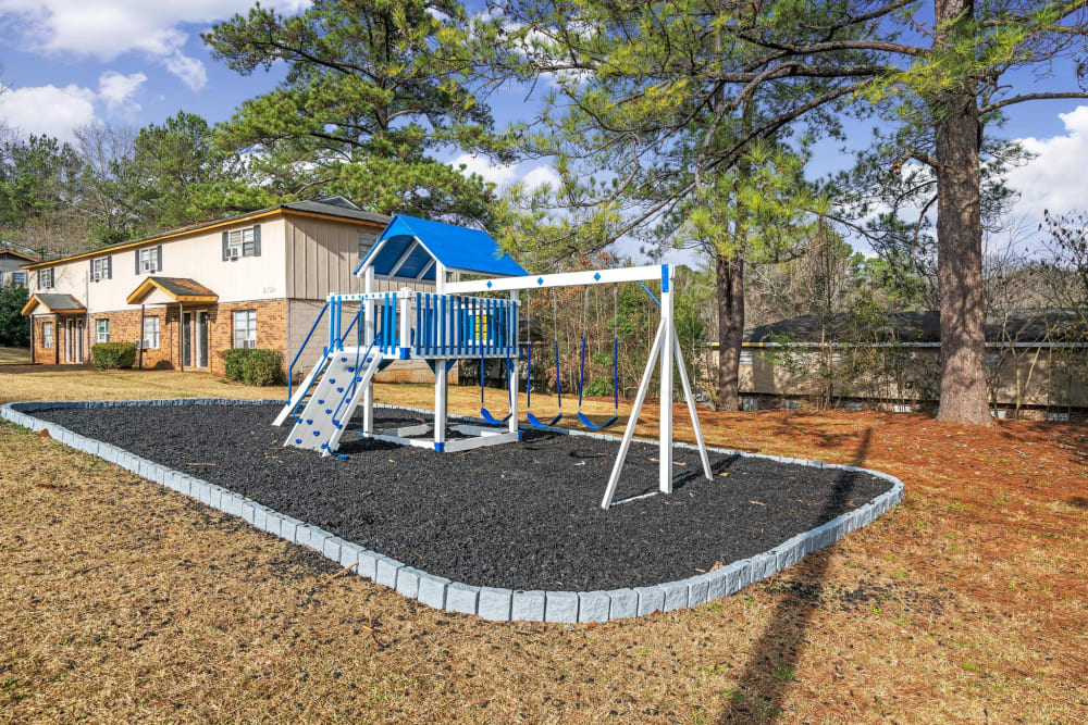 A white and blue playground at Walnut Creek Apartments in Macon, Georgia