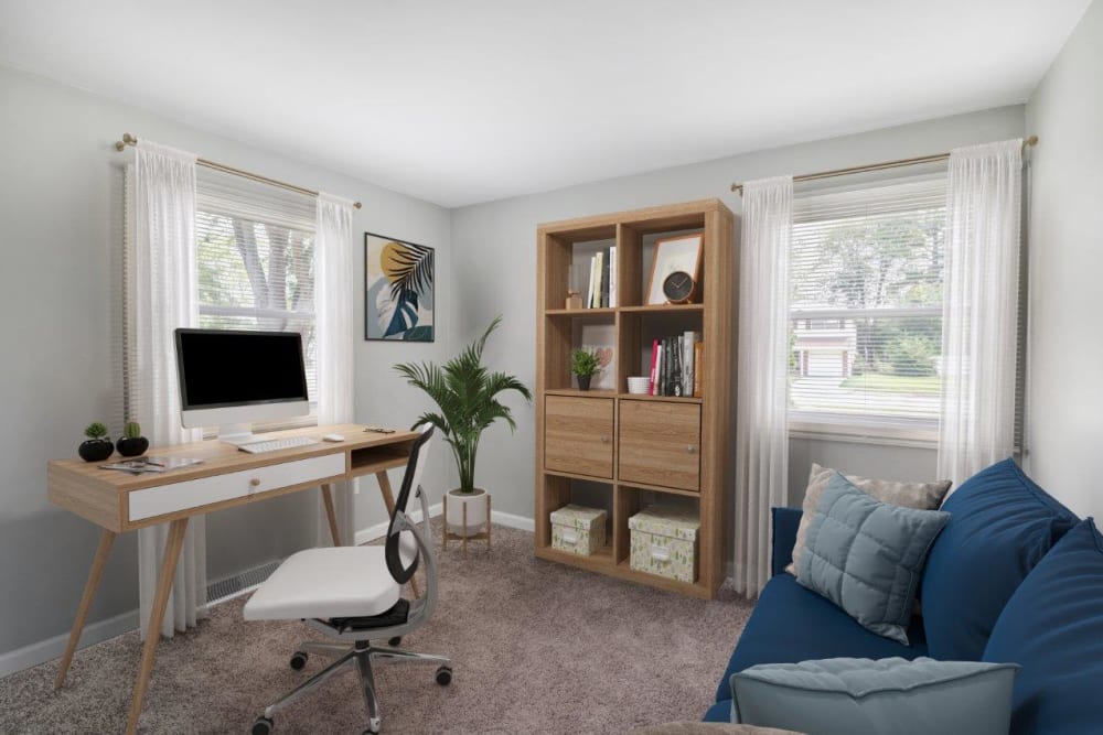 Bedroom staged with an office desk and daybed
