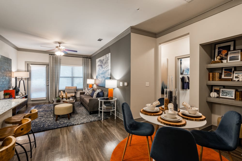 Model living space with large windows at Marquis Seven Meadows in Katy, Texas