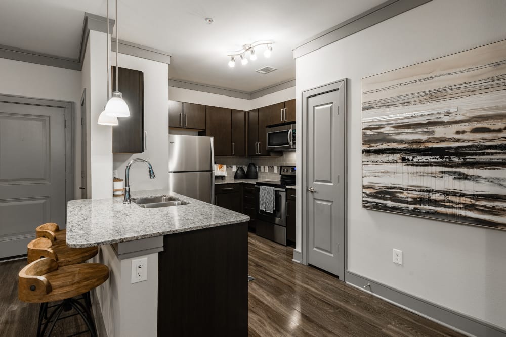 Model kitchen with hardwood floors at Marquis Seven Meadows in Katy, Texas