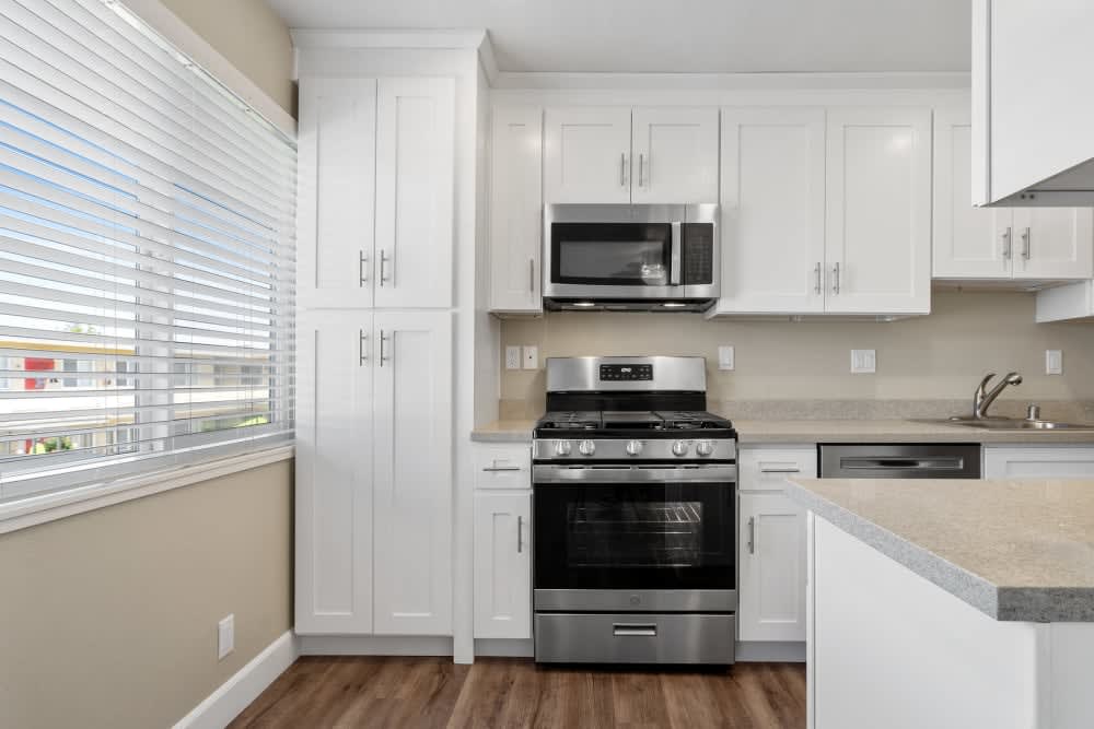 Kitchen with microwave and hardwood-style flooring at Bon Aire Apartments in Castro Valley, California