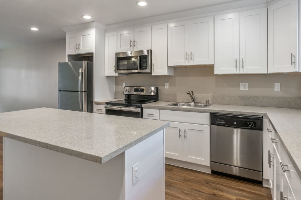 Beautiful modern kitchen with white Shaker cabinetry and stainless-steel appliances at Pentagon Apartments in Fremont, California