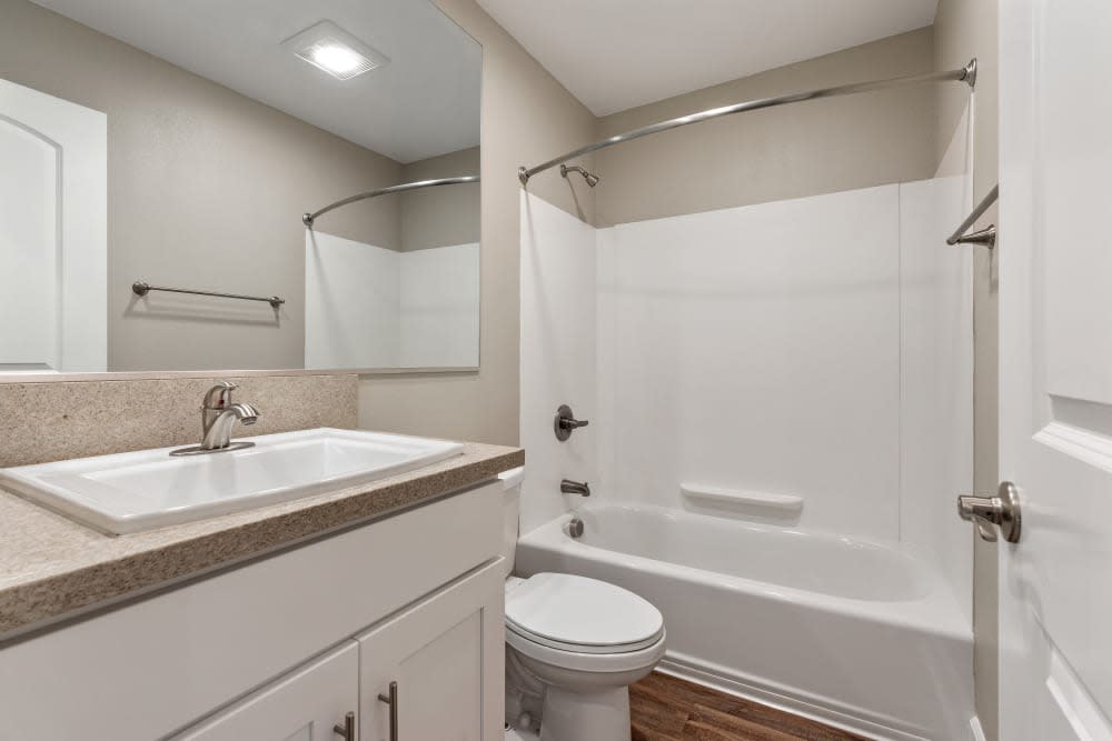 Bathroom with white cabinetry and a tub/shower at Pentagon Apartments in Fremont, California